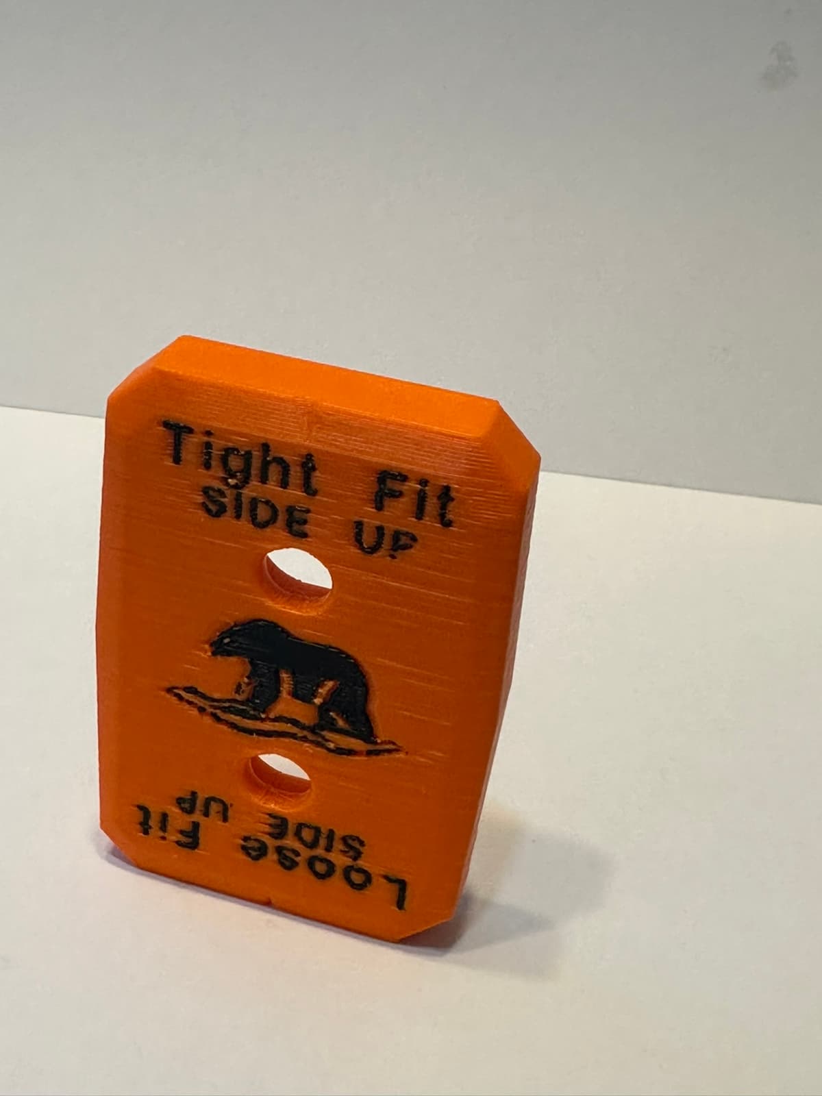 WaterPORT Accessory Mount in orange, showing the Tight Fit / Loose Fit side markings